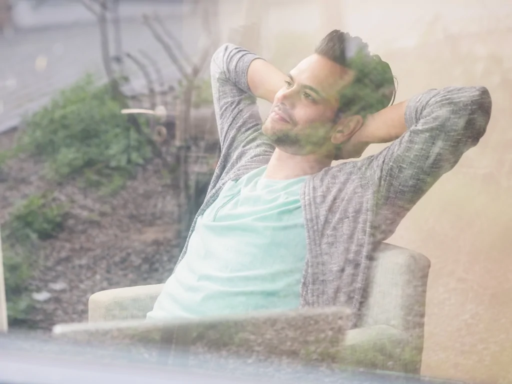 Man relaxing and contemplating in a peaceful outdoor setting